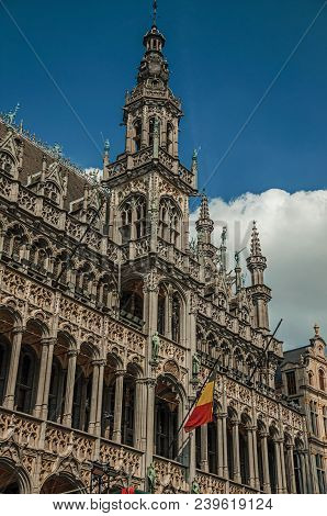 Richly Decorated Facade In Gothic Style Of Brussels City Museum And Belgian Flag, At Grand Place. Vi