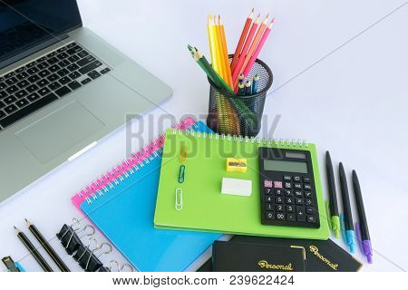 Multiple Stationery Items For Office And School And A Laptop.
