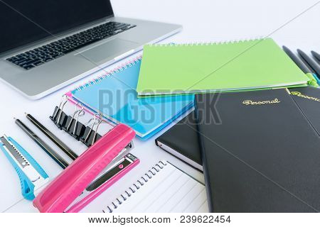 Multiple Stationery Items For Office And School And A Laptop From Corner Perspective.