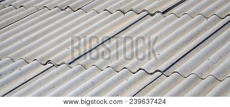 A Fragment Of A Gray Slate Roof Of An Old Sample Made Of Asbestos Material