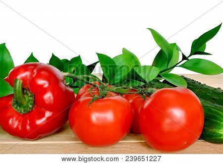 Red Fresh Tomatoes And Sweet Pepper With Cucumber Isolated On White Background. Vegetables On A Wood