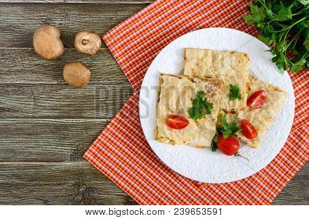 Pie, Casserole Pita With Mushrooms, Cottage Cheese And Cheese On A White Plate On A Wooden Backgroun