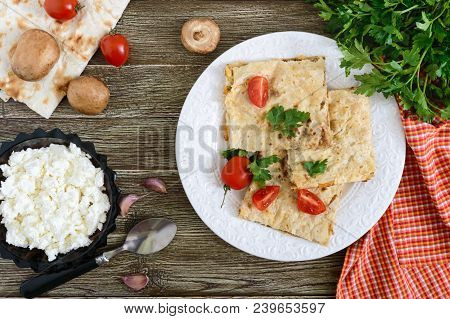 Pie, Casserole Pita With Mushrooms, Cottage Cheese And Cheese On A White Plate On A Wooden Backgroun