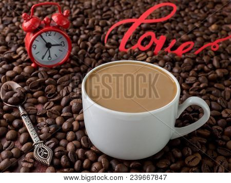 Cup Of Coffee With Milk On Background Of Coffee Beans