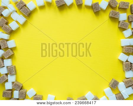 Cubes Of White And Brown Sugar On Yellow Background