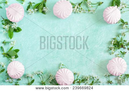 Delicate Frame Of Marshmallows And Cherry Blossoms. Delicious Airy Dessert. Concept Of Light Air Des