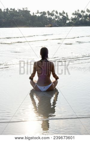 Girl Who Practices Yoga On The Beach