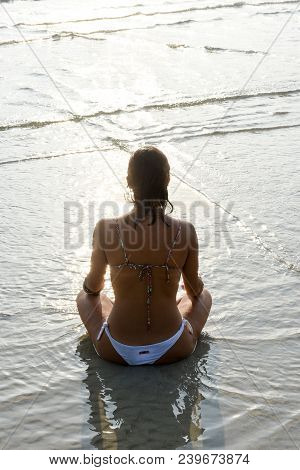 Girl Who Practices Yoga On The Beach