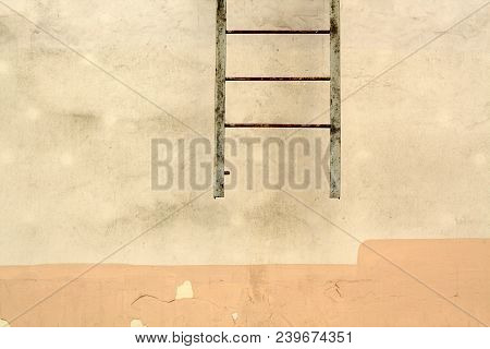 Fire Escape Ledder On Cement Wall. Urban Background And Texture.