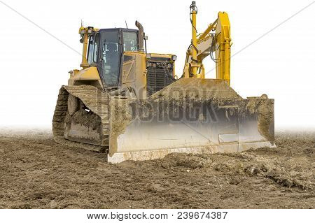Yellow Bulldozer At A Loamy Construction Site, Partly Isolated In White Back