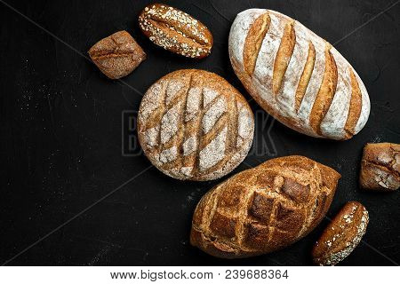 Bakery - Gold Rustic Crusty Loaves Of Bread And Buns On Black Chalkboard Background. Still Life Capt