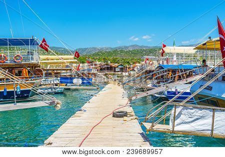 Kekova, Turkey - May 10, 2017: The Wooden Pier With Rows Of Yachts And Pleasure Boats On Both Sides 