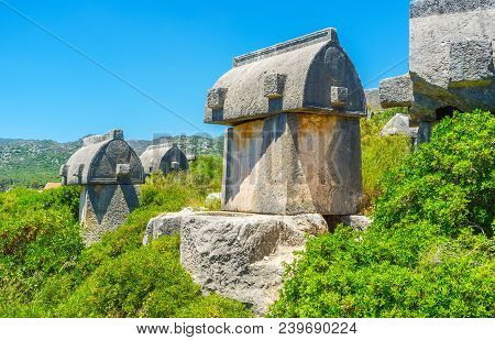 The Ancient Sarcophagi In Lush Greenery On The Mountain Slope, Ucagiz, Kekova, Turkey.