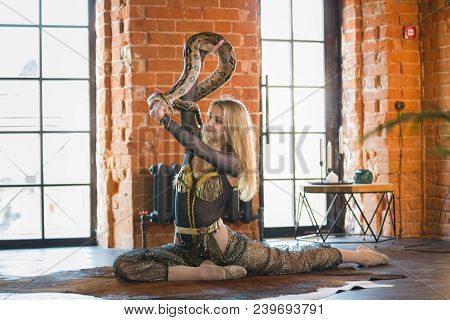 Slim Young Woman Performing Dance With A Snake In Studia, Close Up