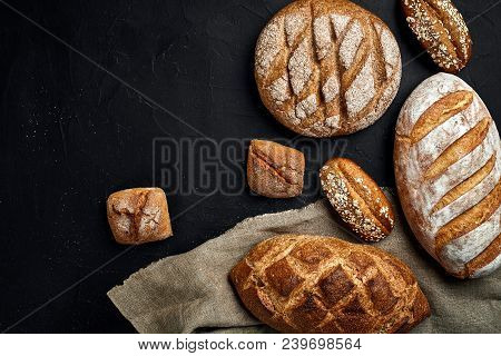 Bakery - Gold Rustic Crusty Loaves Of Bread And Buns On Black Chalkboard Background. Still Life Capt