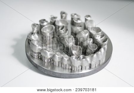 Object Printed On Metal 3d Printer. Dental Crowns Created In A Laser Sintering Machine Close-up. Dml