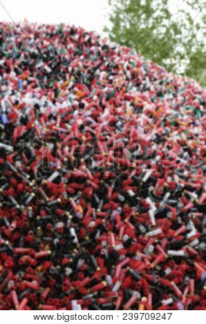 Blurred Abstract Background Of Sport Cartridges. Sports Shooting On Skeet.  A Mountain Of Cartridges