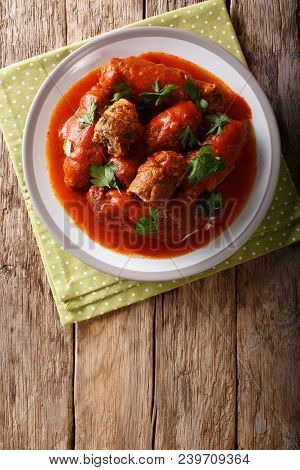 Italian Food: Beef Steak Stuffed With Parsley And Parmesan Cheese In Tomato Sauce Close-up On A Plat