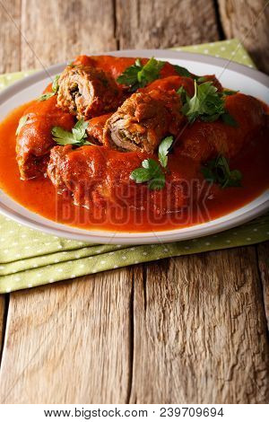 Italian Beef Steak Braciole Stuffed With Parsley And Cheese In Tomato Sauce Close-up. Vertical