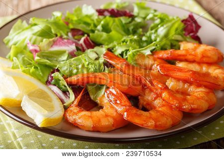 Honey Soy King Prawns And Fresh Salad Close-up On A Plate. Horizontal