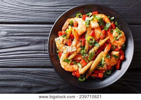 Portion Of Spicy Shrimp With Pepper, Garlic, Corn Cob And Herbs Close-up. Horizontal Top View