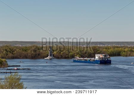 The Barge For Transportation Of Oil Products Turns From The Riverbed Of The Volga Near The Lighthous