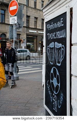 Moscow, Russia - April 30, 2018: People Near The Chalkboard On Solyansky Proezd With The Advertiseme