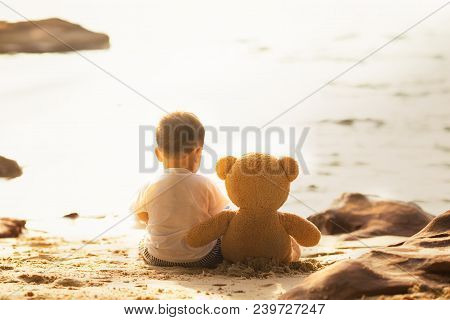 Baby And Teddy Bear Sit Togather On The Beach, This Immage Can Use For Kid, Friend, Love, Travel, Lo