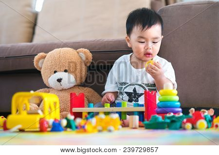 Asian Boy Play A Toy With Teddy Bear In Lieving Room, This Immage Can Use For Fun, Toy, Baby, Educat