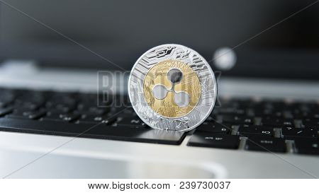 Silver Gold Ripple Coin On A Laptop Keyboard Closeup. Blockchain Mining. Digital Money And Virtual C