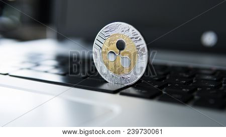Silver Gold Ripple Coin On A Laptop Keyboard Closeup. Blockchain Mining. Digital Money And Virtual C