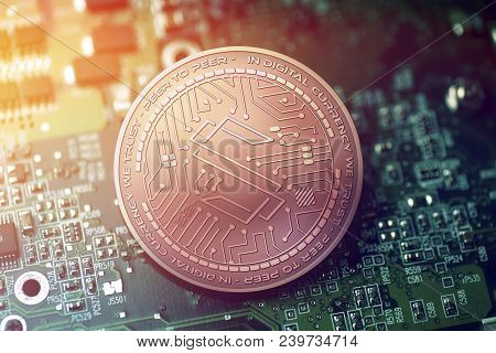 Shiny Copper Substratum Cryptocurrency Coin On Blurry Motherboard Background Token