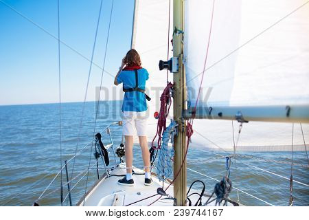 Young Man Sailing. Teenager Boy On Sea Sail Boat.
