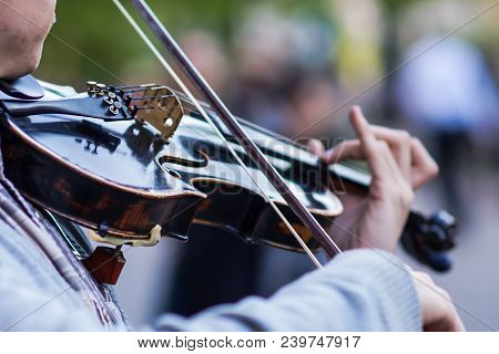 The Violin Is Big, Against The Backdrop Of The Street