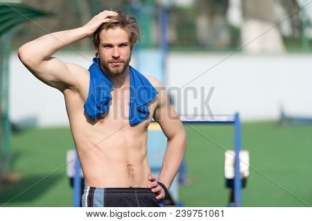 Sportsman Touch Hair With Blue Tshirt On Neck. Bearded Man With Fit Torso Muscles At Stadium. Athlet