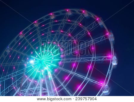 Carnival Ride Showing A Spinning Ferris Wheel In Action- Long Exposure Shot.