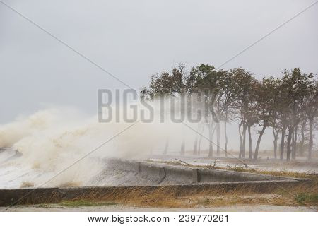 A Hurricane At Sea. Large Waves Through A Concrete Parapet
