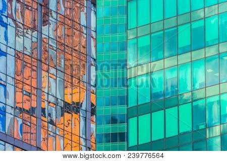 Angle Glass Red, Burgundy, Brown, Green, Aqua Clolrs Facades Of A Window Of Financial Skyscrapers, A