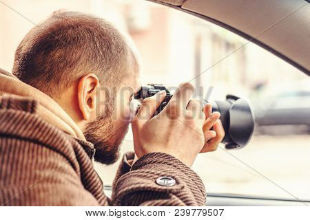 Investigator Or Private Detective Or Reporter Or Paparazzi Sitting In Car And Taking Photo With Prof