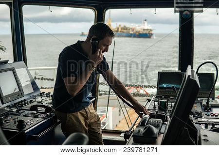 Deck Navigation Officer On The Navigation Bridge. He Speaks By Vhf Radio, Gmdss Watchkeeping, Collis