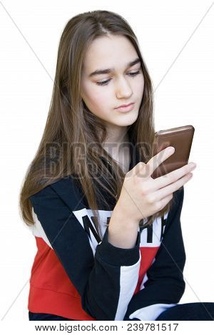 Vertical Portrait Of Young Sad Serious Beautiful Girl With Long Blonde Hair With A Smartphone. Teen 