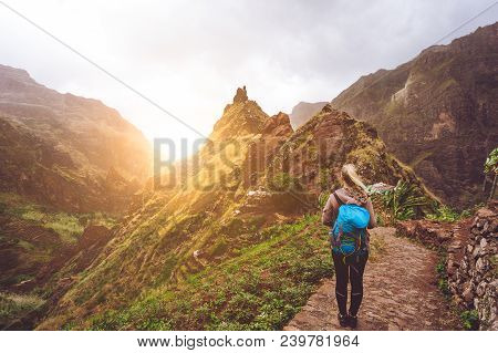 Girl Walking Down Along The Trekking Route To Verdant Xo-xo Valley. Warm Sunlight Seable On Horizont