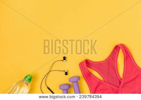 Sports And Fitness Accessories With Water On Yellow Background. Flat Lay, Top View.