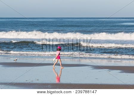 Solana Beach, California/usa - April 22, 2018:  A Small Child Walks Alone On The Shore At Low Tide N