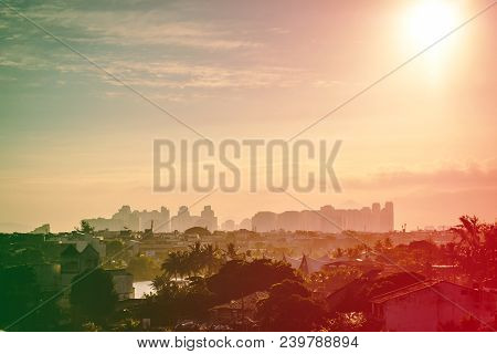 Building In Barra Da Tijuca Seen From Above With Houses On The Hill During Sunset, Golden Light. Bar