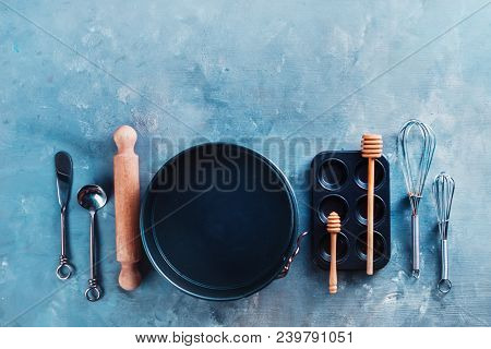 Baking Forms And Muffin Tin With Whisks, Spoons, Flour, Sugar And Spices On A Marble Kitchen Table. 