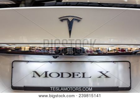 Berlin, Germany - December 6, 2017: Tesla logo on a Tesla car. Tesla, Inc. is an American company that specializes in electric automotives, energy storage and solar panel manufacturing.
