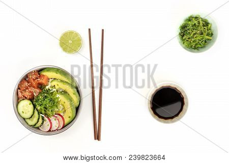 Hawaiian Tuna Poke Salad On White, With Wakame Seaweed Salad, Chopsticks, A Lime, A Bowl Of Soy Sauc