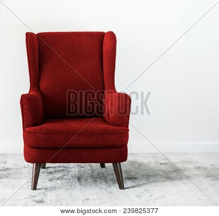 Wing back chair on a carpet no people