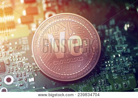 Shiny Copper Veritaseum Cryptocurrency Coin On Blurry Motherboard Background Token
